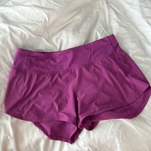 Lululemon Speed up MR 4” Size 8 Shorts in the color Vivid Plum